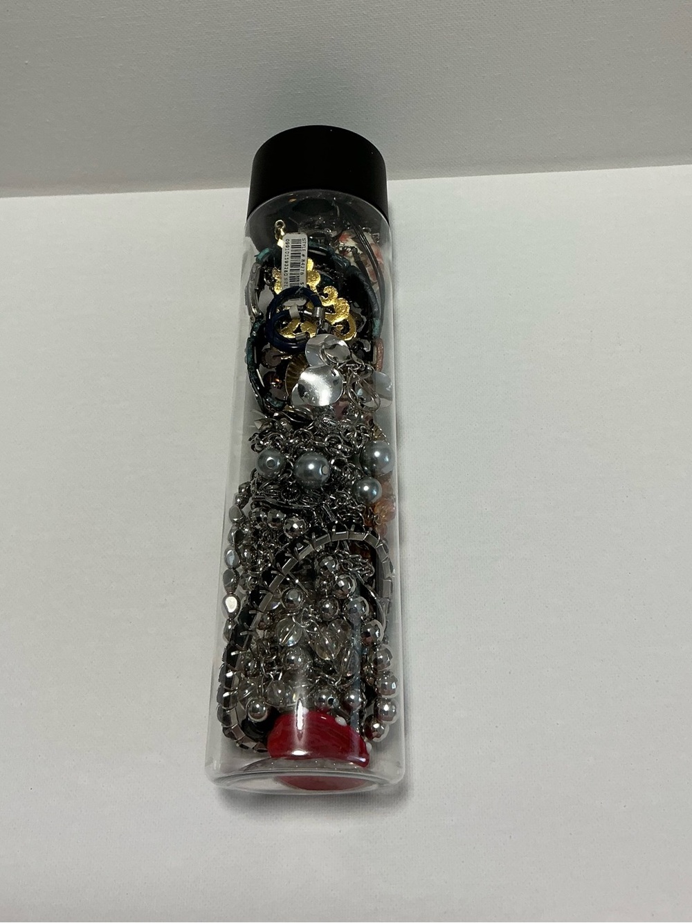 Clear Jewelry Tube Filled with 25 Mixed Costume Jewelry Multicolor Items.